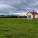 NZL STL OtahuFlat 2018MAY05 School 004  What initially drew my eye to the building was the striking contrast of the cream coloured walls and red roof against lush green pastures and black rolling clouds of the incoming rain. : - DATE, - PLACES, - TRIPS, 10's, 2018, 2018 - Kiwi Kruisin, Day, May, Month, New Zealand, Oceania, Otahu Flat, Saturday, School, Southland, Year